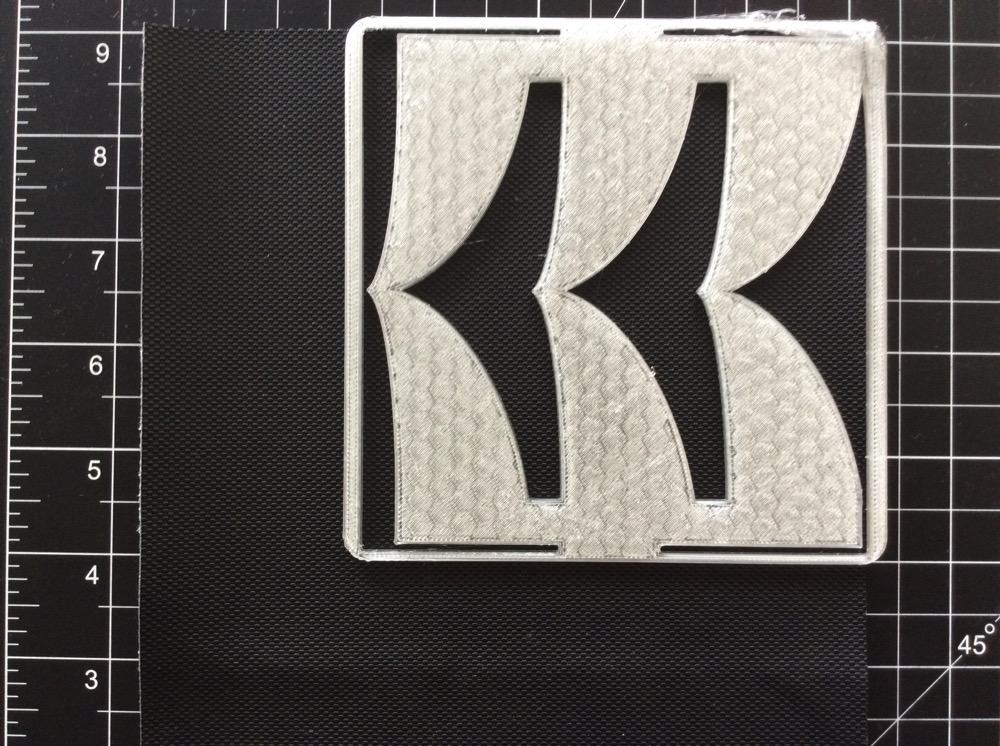 3D-printed template on fabric, awaiting cutting.