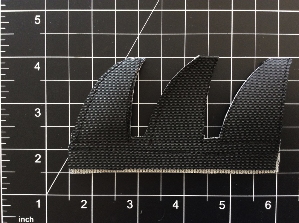 Sewn together: Two parallel seams just below where the fins meet the bottom portion, and one stitch along the perimeter of each fin.