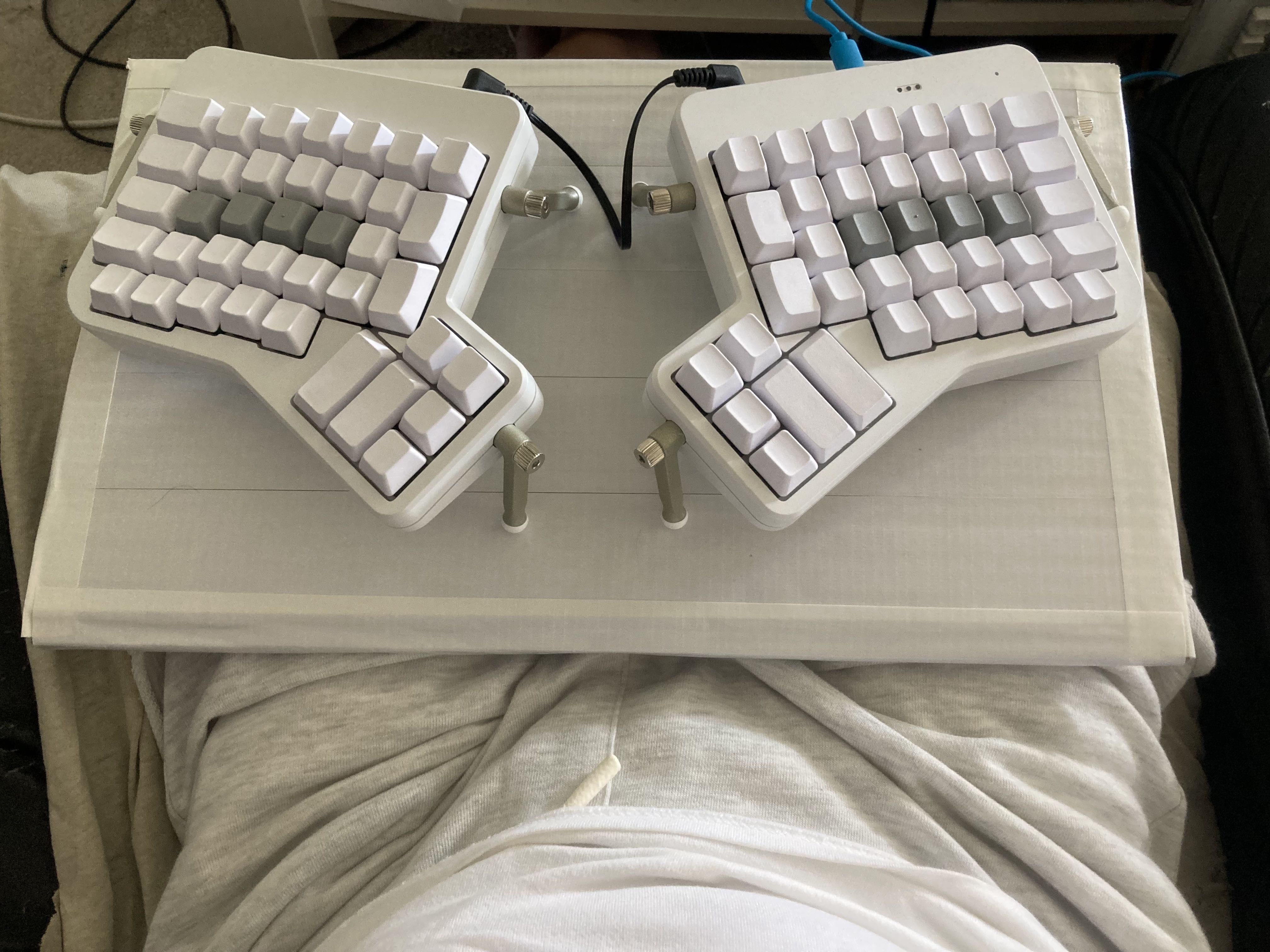 Photo of the keyboard tray in use, sitting on my lap, with the ErgoDox keyboard on top of it.