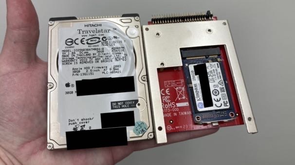 The two-and-a-half-inch spinning-rust hard drive, and the mSATA SSD in its IDE adapter, side by side in my hand.