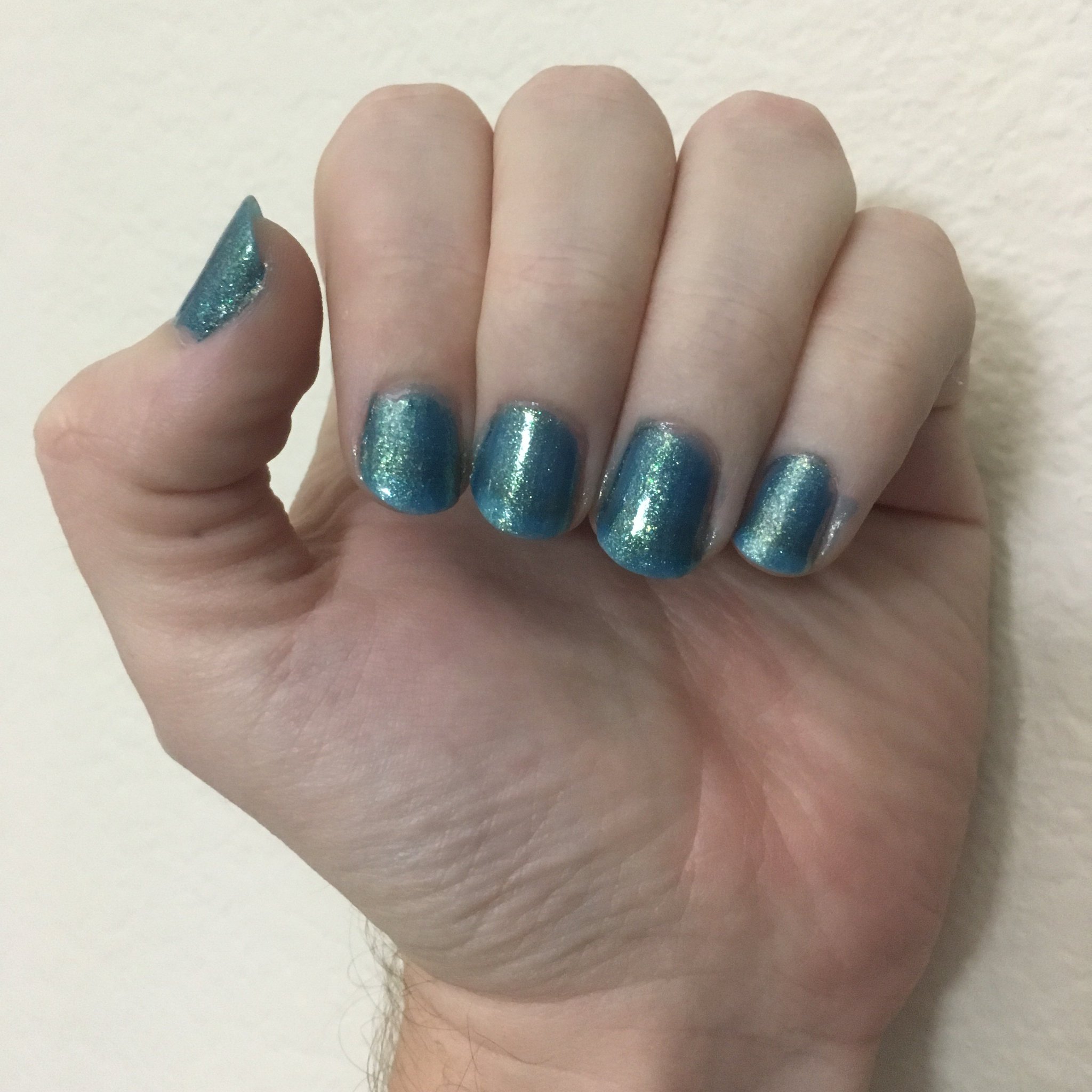 L.A. Colors “Mermaid”, a teal color with a fine glittery texture.