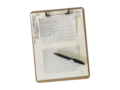 A clipboard holding one postcard holder sheet, with a postcard in each of the two spaces.