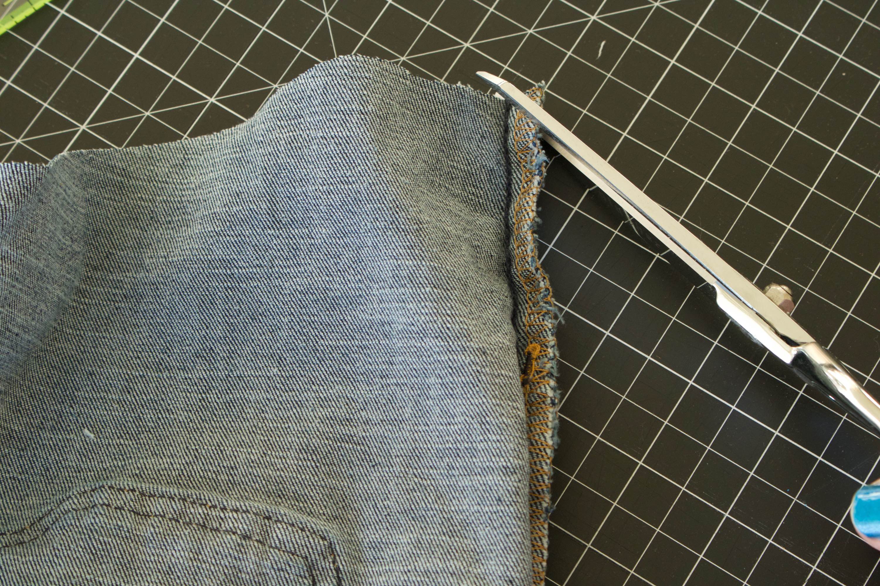 Trimming about a quarter of an inch an outseam diagonally with a pair of shears.